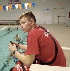 Lifeguard watches closely as swimmers play